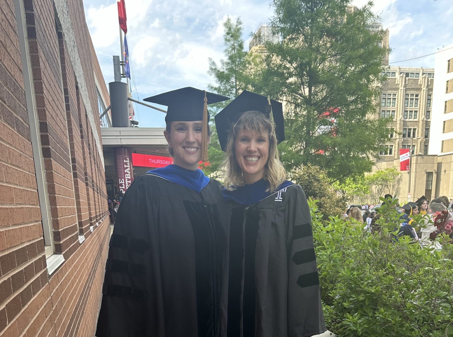 Two graduates in their caps and gowns